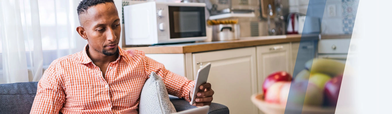Smiling woman with laptop and mobile phone