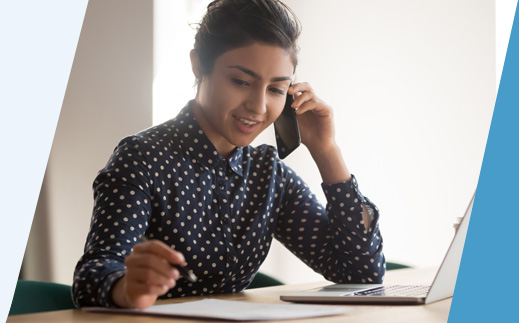 Woman on mobile phone with laptop